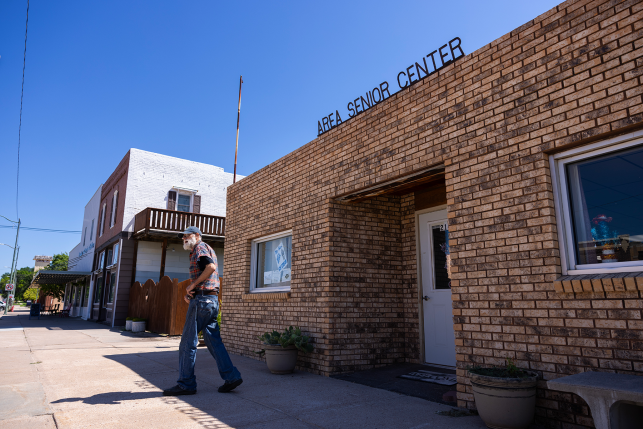 Man walks out of brick building
