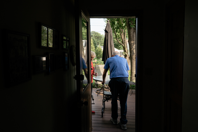 Elderly man and woman at door on their deck