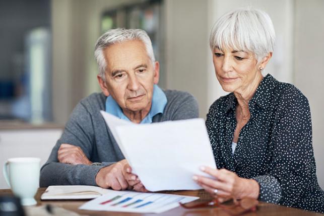 Medicare beneficiaries going over paperwork