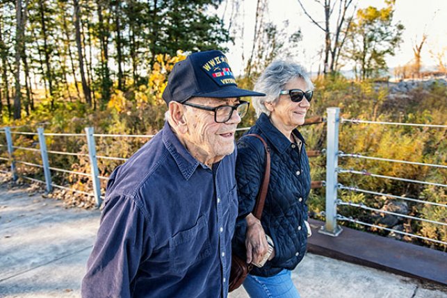 Medicare beneficiary and baby boomer daughter walking