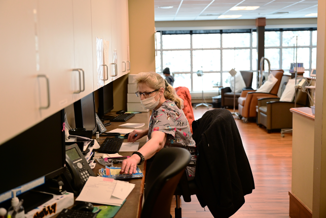 Medical assistant organizing the records of patients in cancer center