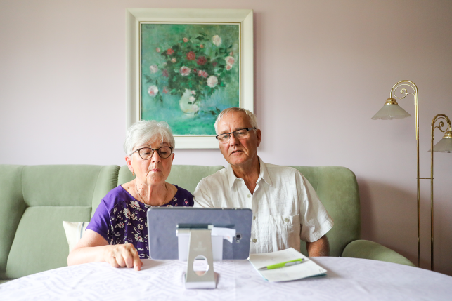 Two seniors look at computer
