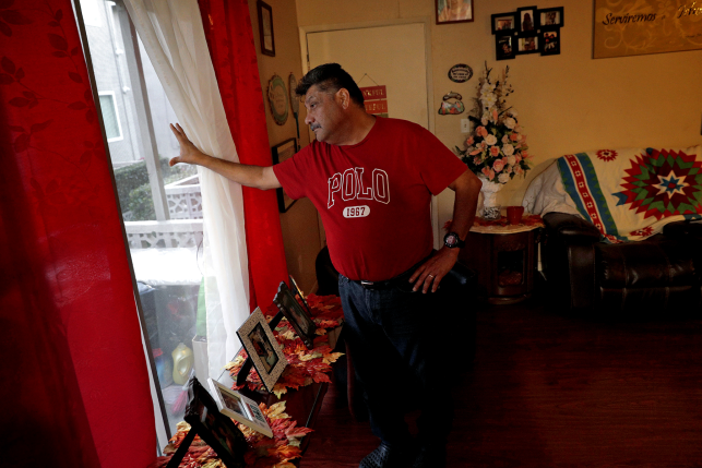 Man looks out window in home