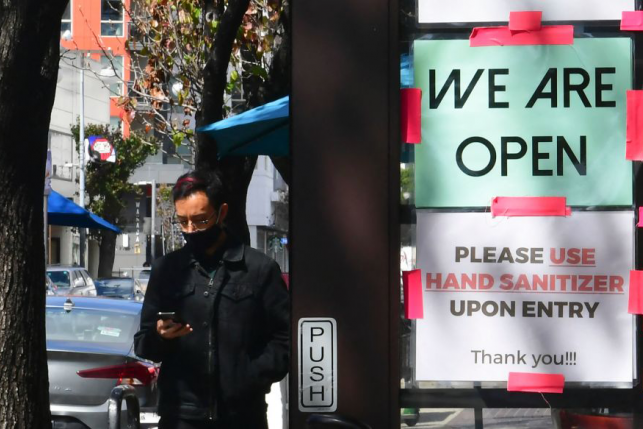 Man in front of an open sign in Los Angeles