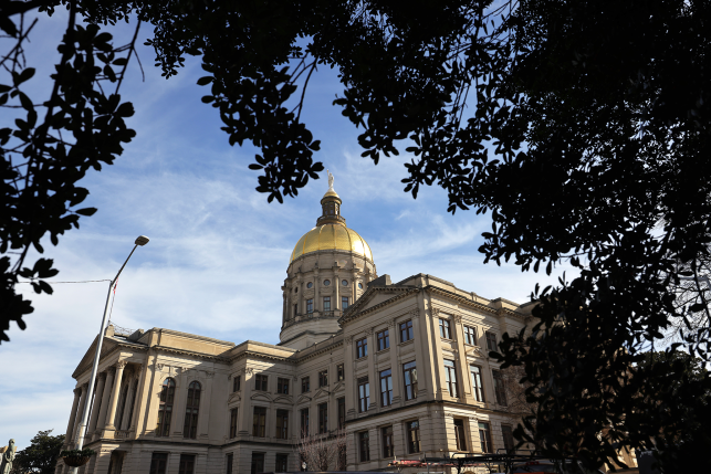 Side view of state capitol building from under a tree