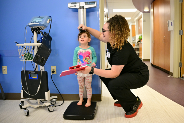 Child standing on scale at doctors office