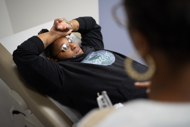 Woman lies on patient bed