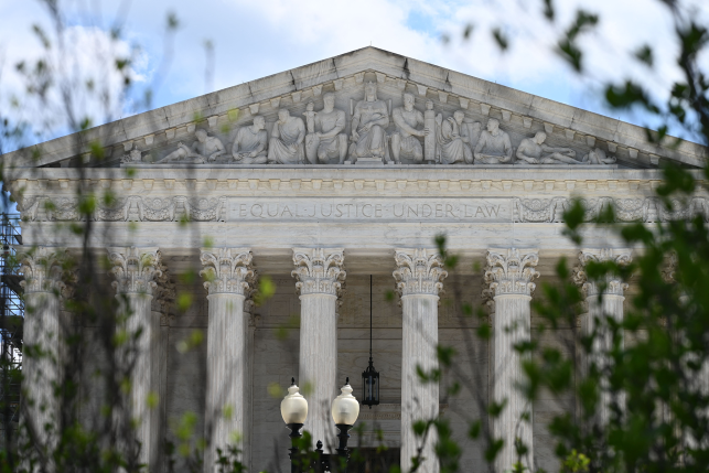 Photo, view of Supreme Court building thru trees