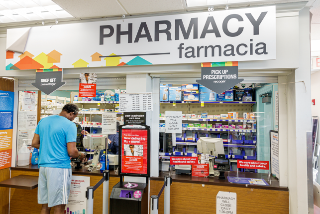 Photo, man at pharmacy counter