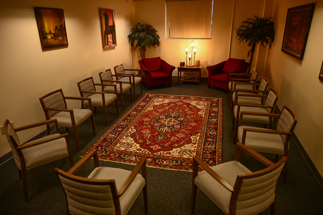 Room view of chairs around a rug