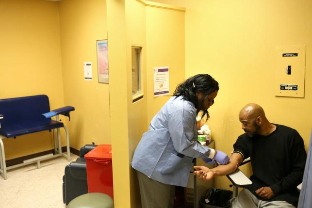 Image of a nurse doing blood work on a patient