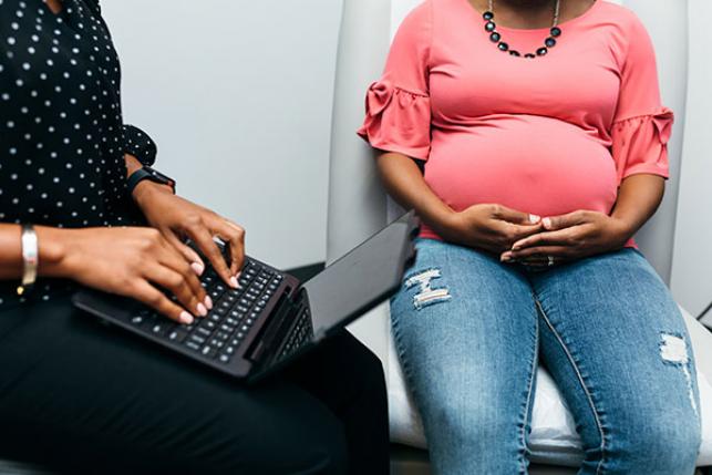 black pregnant woman getting doctor checkup