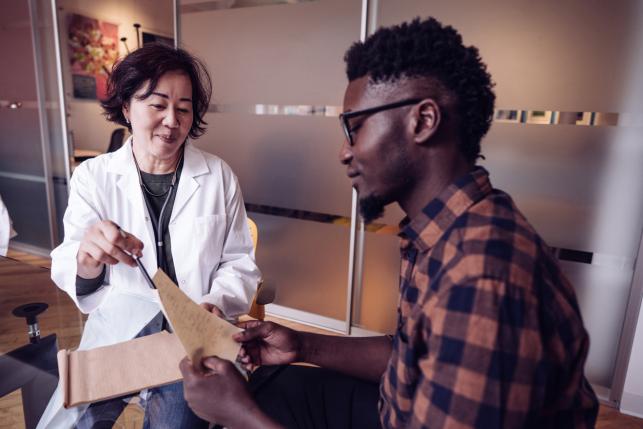 doctor consults with patient in office