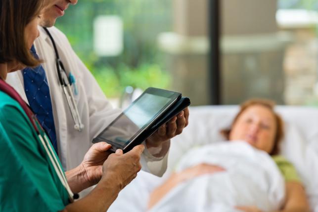 Doctors use electronic health records with patient