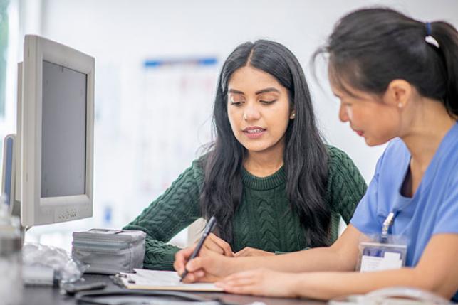 female with health insurance visiting doctor