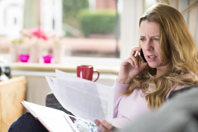 Underinsured woman looking at medical bills