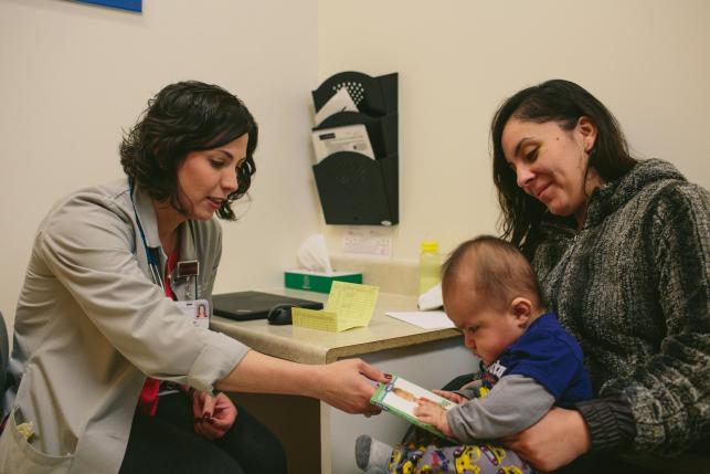 Mother and baby sitting in medical office with doctor