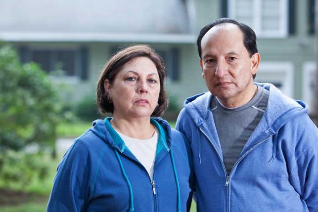 concerned-couple-in-front-of-house people health insurance