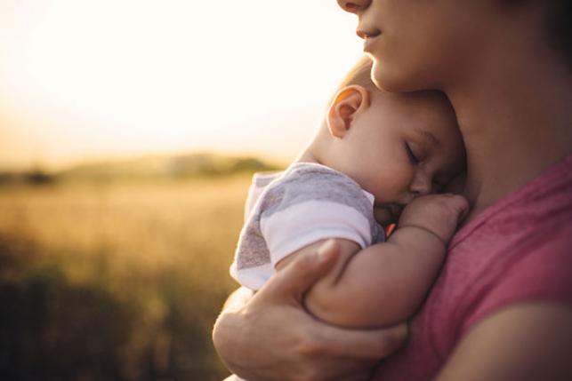 rural woman with new infant in field