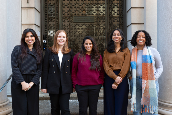Five women posing for a photo standing in front of the Commonwealth Fund building