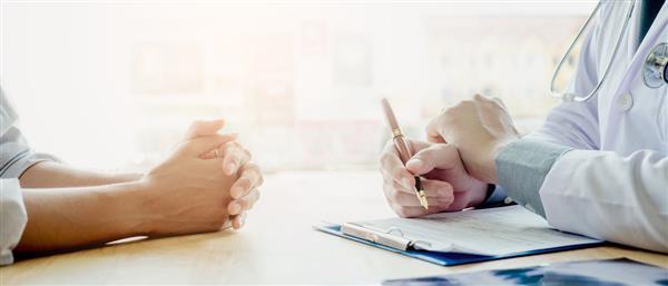 Doctor and patient go over paperwork for insurance marketplace
