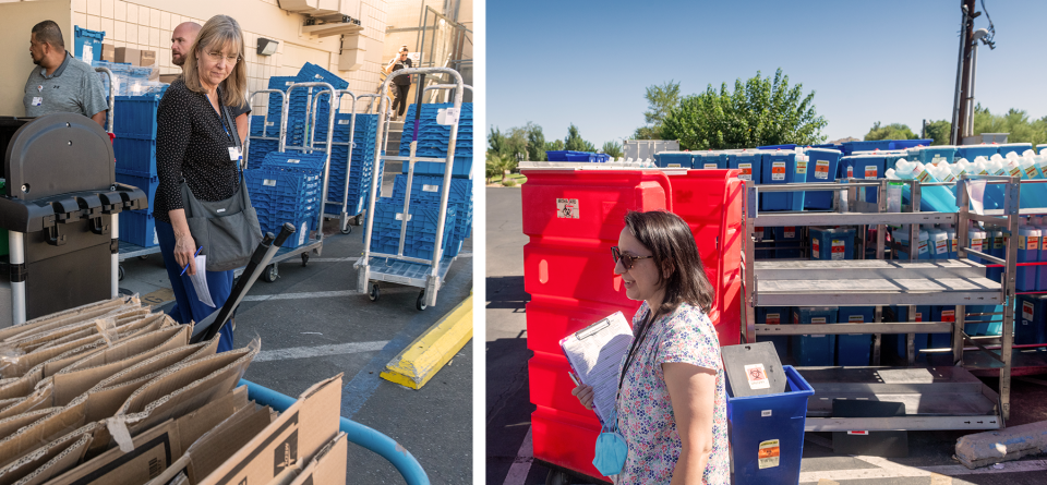 People tour the exterior of a health facility looking at cardboard boxes and various waste bins