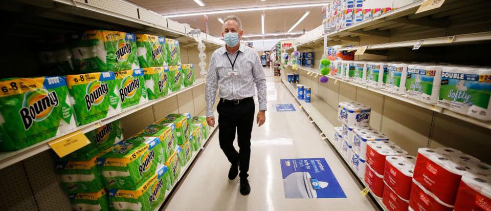 Senior worker in grocery store ready for COVID-19