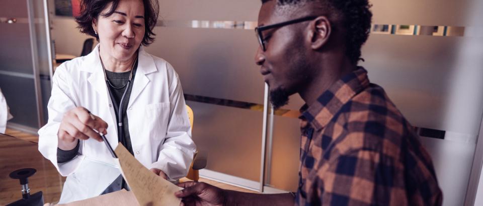 doctor consults with patient in office