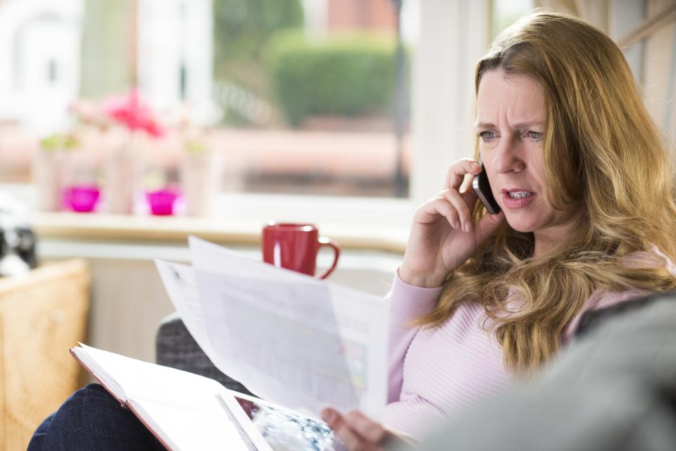 worried about bills Underinsured woman looking at medical bills