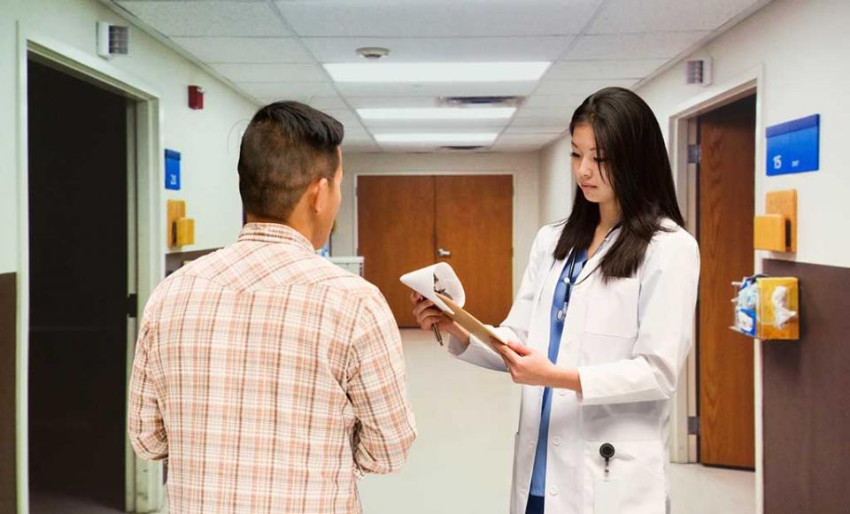 doctor-and-patient-with-paperwork doctor patient health insurance