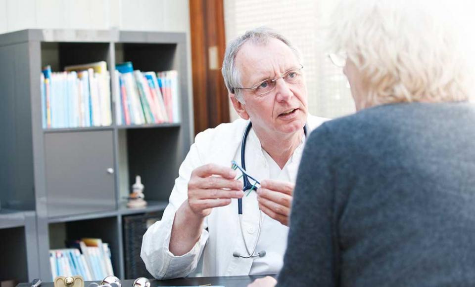 doctor-discusses-device doctor patient health insurance