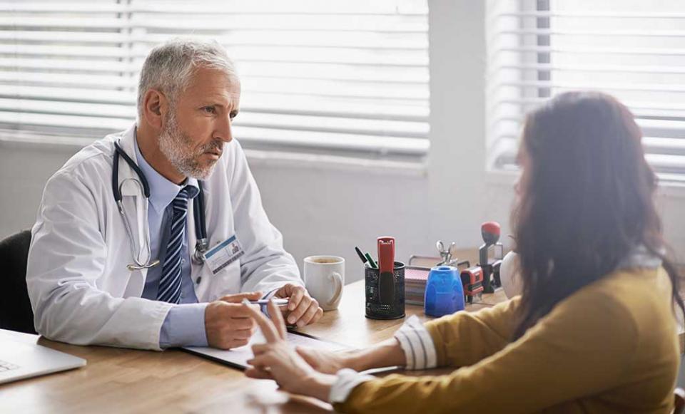 doctor-explaining-paperwork doctor patient health insurance