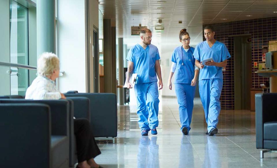 doctors-walking-down-hall doctor patient health insurance
