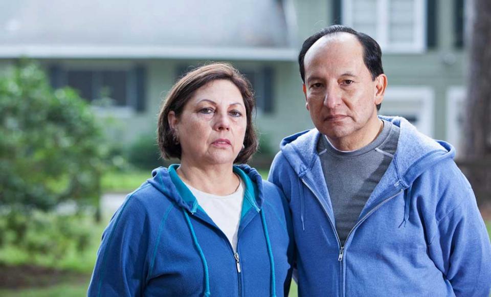 concerned-couple-in-front-of-house people health insurance