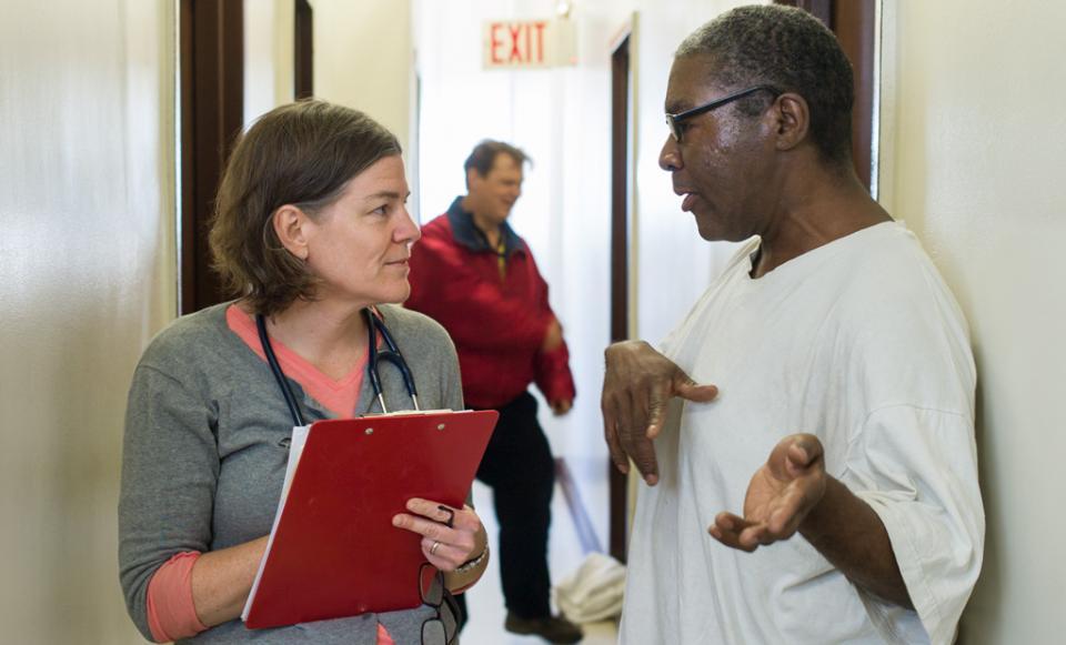 patient and doctor talk in hall