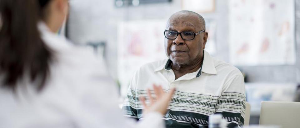 senior with Medicare discusses care with doctor