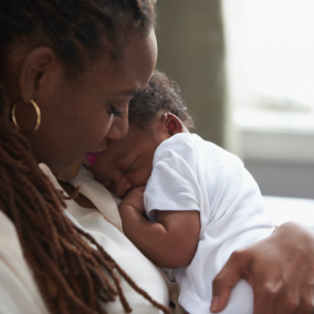 Mother cradling newborn baby