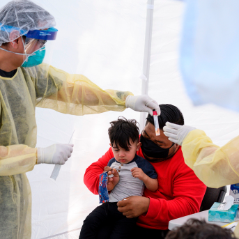 Child getting tested for COVID-19 at a mobile testing station