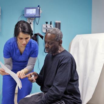Nurse reviews surgery instructions with patient