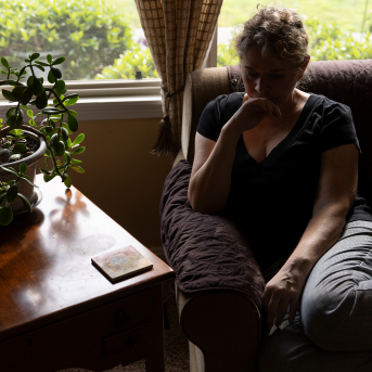 Woman sits in chair