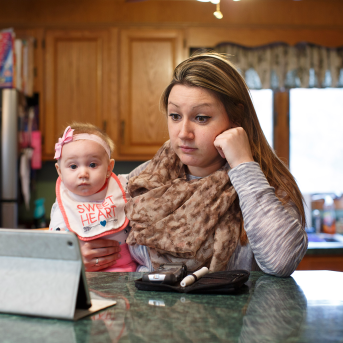 Woman and baby look at ipad