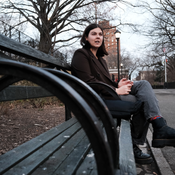 Photo, woman sits on bench in park
