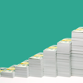 Stacks of U.S. hundred dollar bill bundles in ascending order on white shelf, green background.
