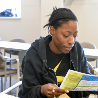 Photo, woman reading pamphlet