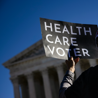 A supporter of the Affordable Care Act (ACA) stands in front of the Supreme Court of the United States as the Court begins hearing arguments from California v. Texas about the legality of the ACA on November 10, 2020 in Washington, DC.