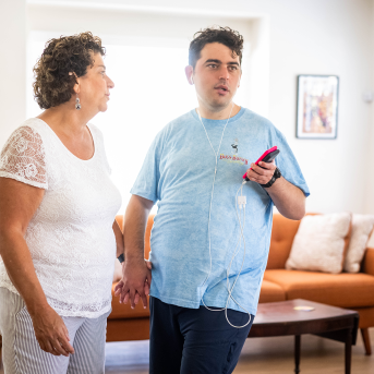 Woman and adult son hold hands