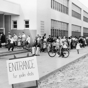 First and second graders at the Kit Carson School in San Diego line up for Salk Polio vaccine shots on April 16, 1955.
