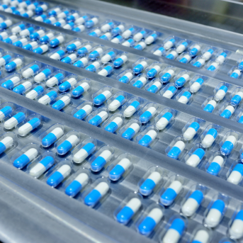 white and blue capsule pills in a row