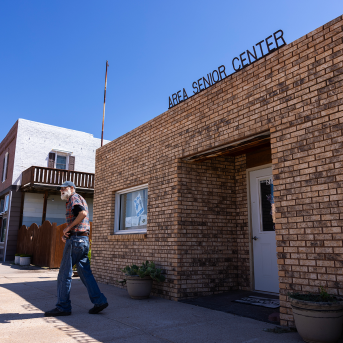 Man walks out of brick building