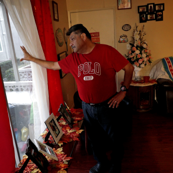 Man looks out window in home